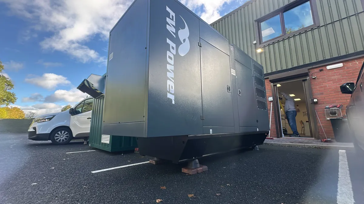 Blackwell 220 kVA diesel generator positioned beside a manufacturing building