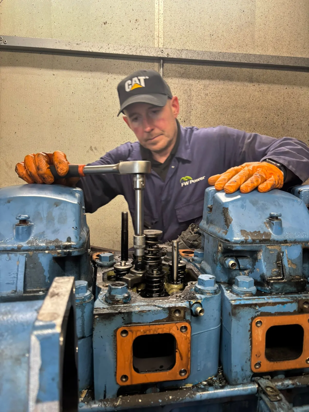 FW Power engineer working on the exposed upper engine assembly during a major generator service in Telford