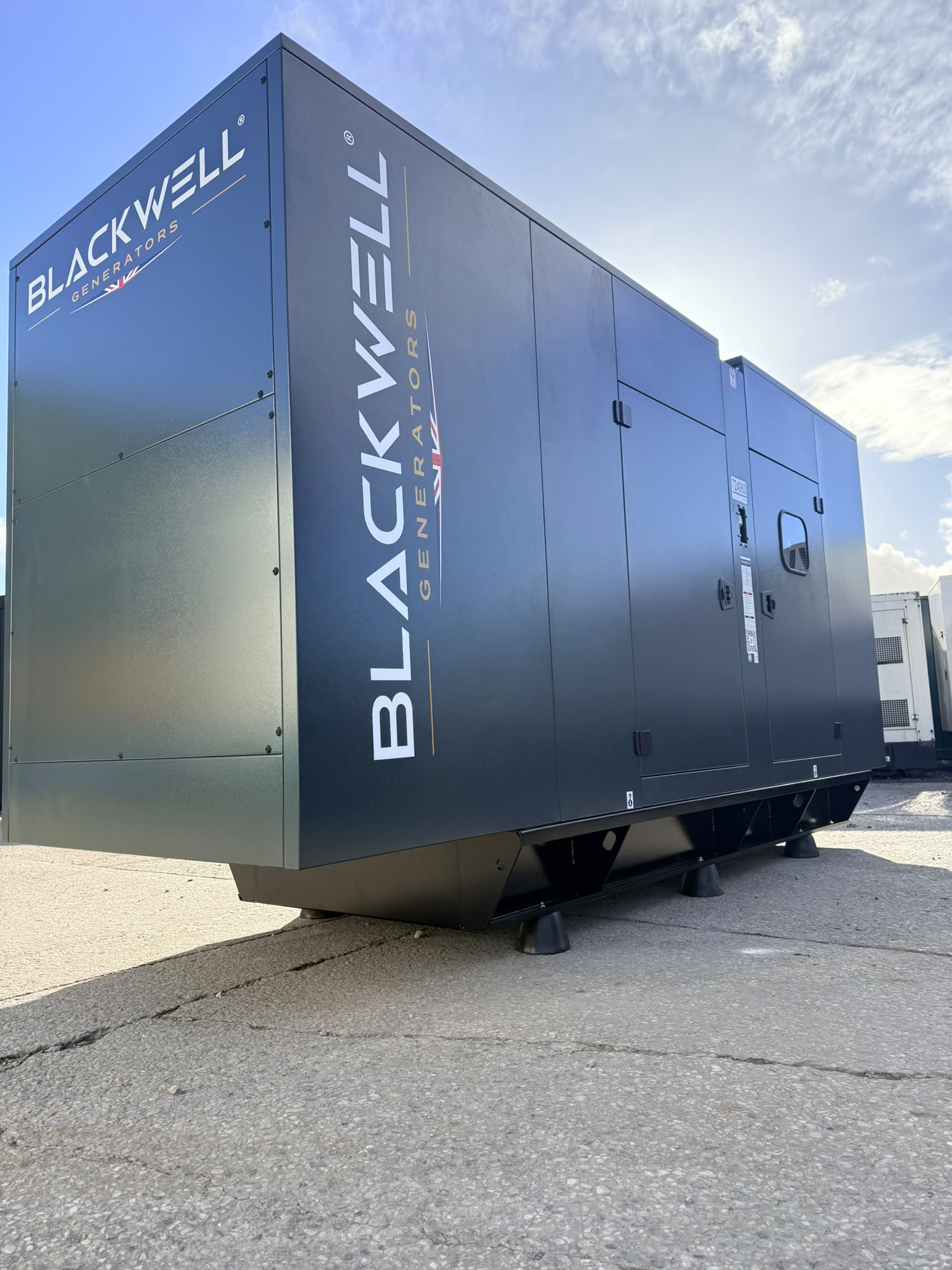 Blackwell diesel generator in a dark grey enclosure, photographed at a three-quarter angle before deployment to Heathrow Airport