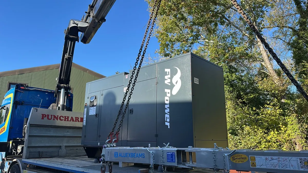 Crane lift positioning a Blackwell 220 kVA diesel generator on site