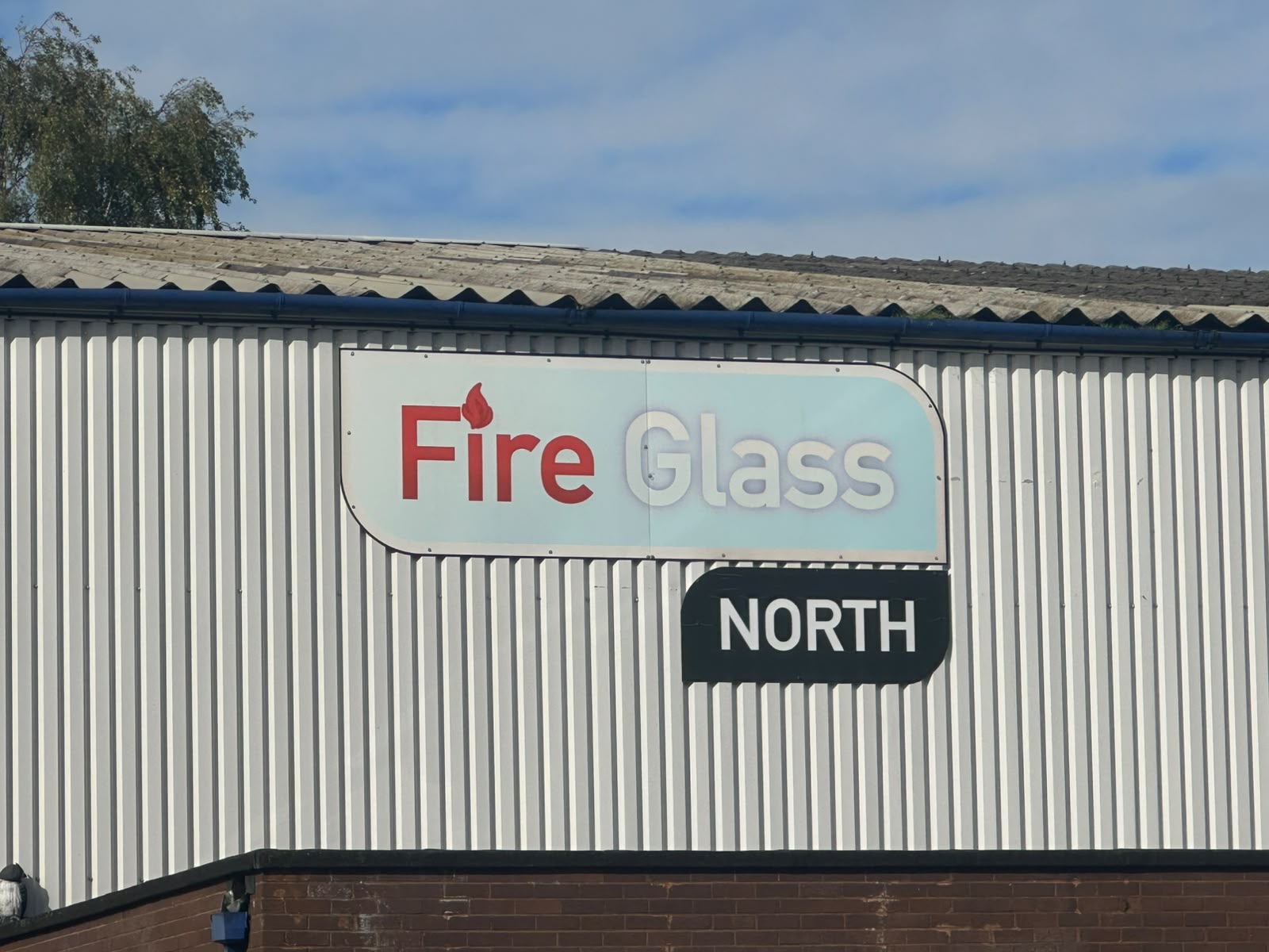 Fire Glass North sign on the exterior of the industrial building.