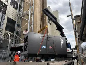 550 kVA NHS standby generator being craned into position at a Cambridge hospital