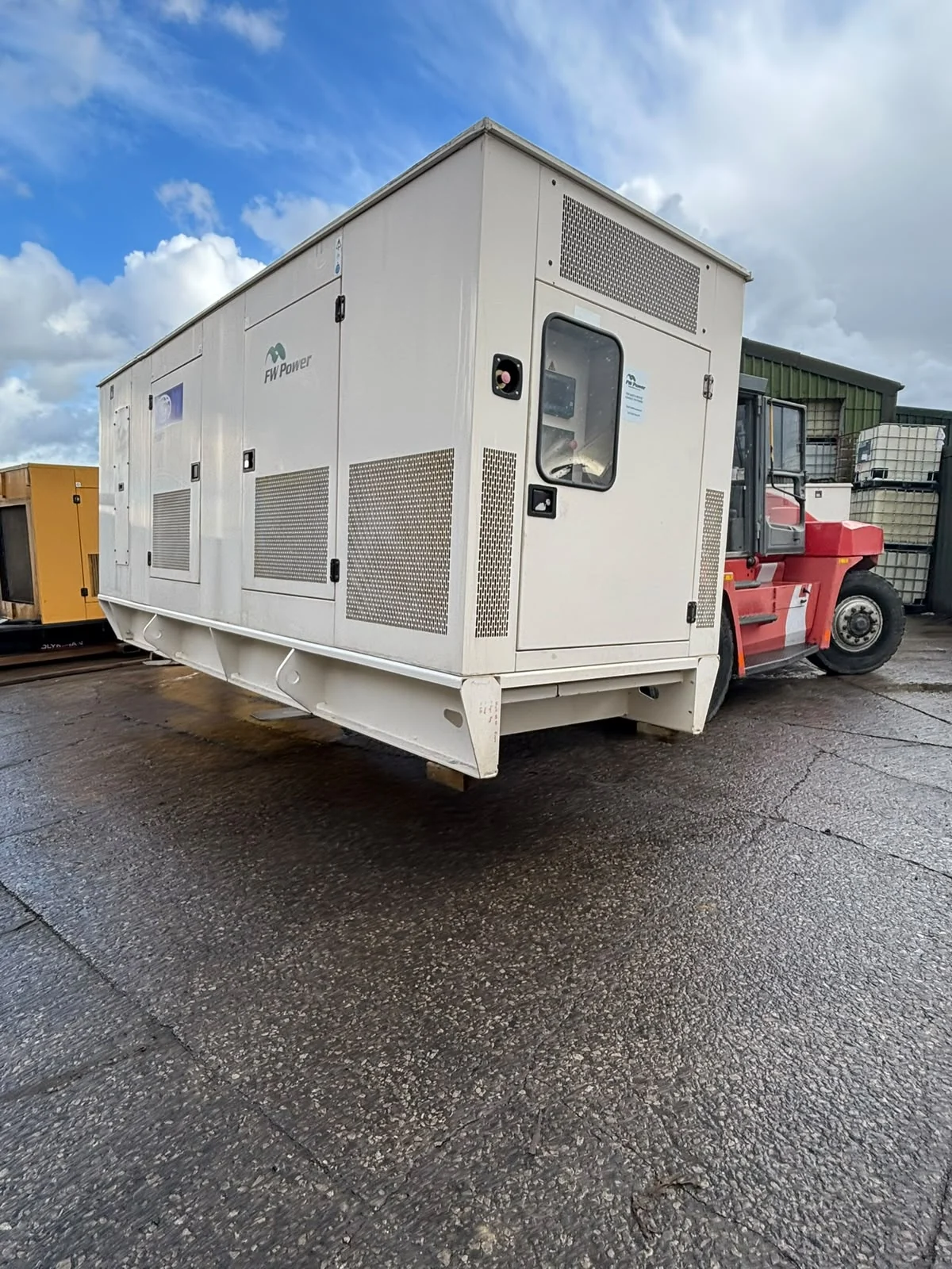 FG Wilson P500P2 generator being handled by forklift at FW Power before collection.