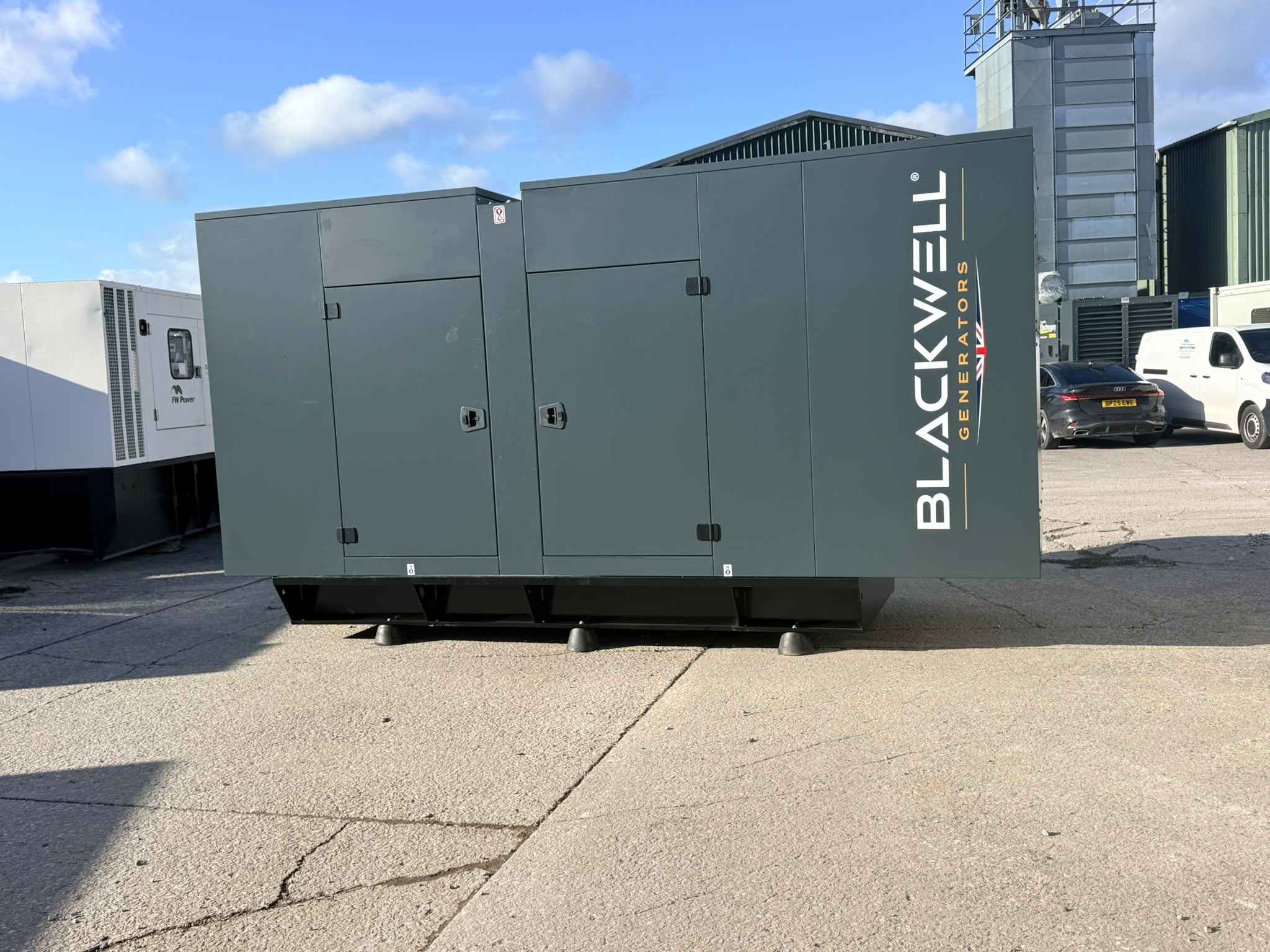 Side view of the enclosed Blackwell backup generator in the FW Power yard ahead of deployment