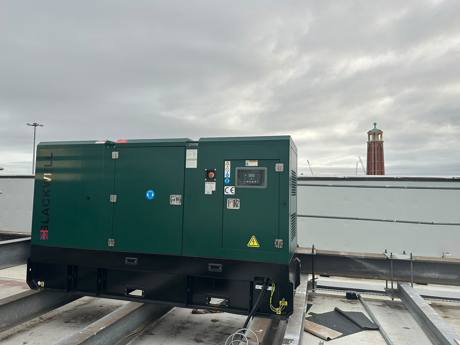 Blackwell B110LS 110 kVA diesel generator on the Trafford Centre rooftop, with the tower in the background.